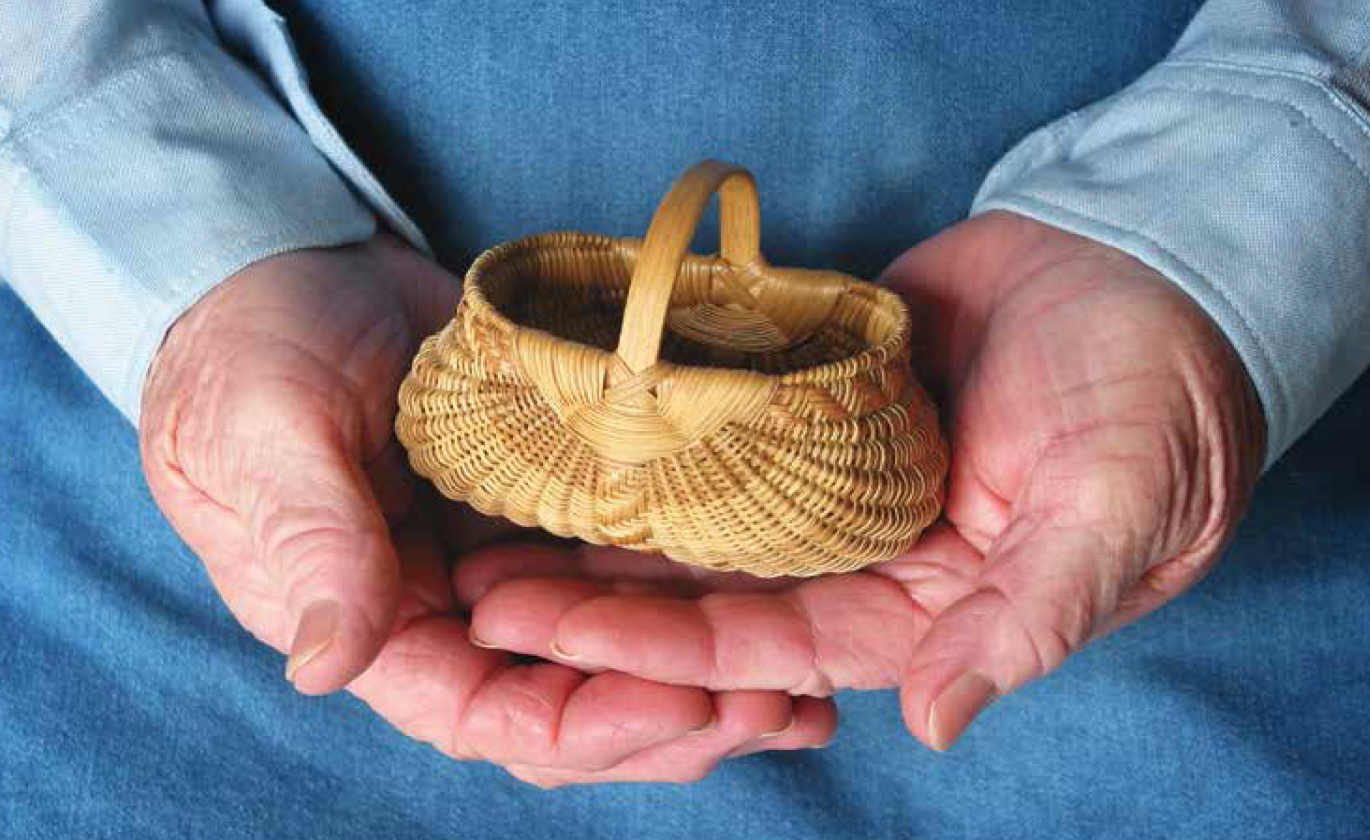 White oak ribbed basket in the hands of its maker, Leona Waddell.